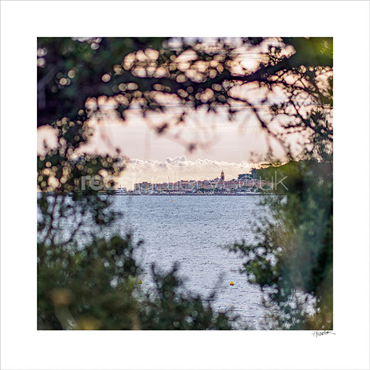 Photograph of St Tropez across the Gulf of St Tropez in early morning light.